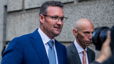 Trevor Milton, left, leaves the Thurgood Marshall United States Courthouse on Sept. 12, 2022, in New York. Nikola Corp. has been awarded $165 million in an arbitration proceeding with its founder and former executive chairman, according to a regulatory filing.