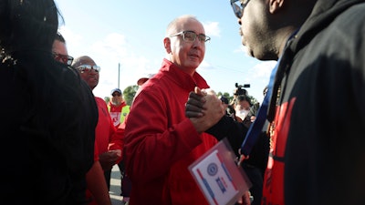 United Auto Workers President Shawn Fain, center, visits striking UAW Local 551 workers outside a Ford assembly center on South Burley Avenue on Oct. 7, 2023, in Chicago.