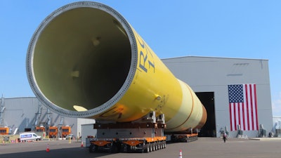 Part of a foundation for an offshore wind turbine rests on rollers outside a manufacturing facility in Paulsboro, N.J. on July 6, 2023.