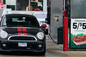 A vehicle is fueled at a gas station in Palatine, Ill., Wednesday, Nov. 8, 2023.