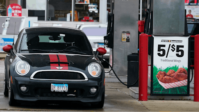 A vehicle is fueled at a gas station in Palatine, Ill., Wednesday, Nov. 8, 2023.