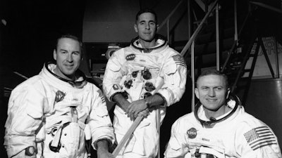 Apollo 8 astronauts, from left, James Lovell, command module pilot; William Anders, lunar module pilot; and Frank Borman, commander; stand in front of mission simulator prior to training in exercise for their scheduled six-day lunar orbital mission at the Kennedy Space Center in Florida, Dec. 18, 1968.
