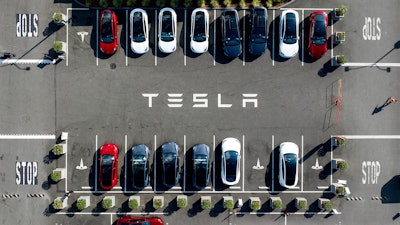 Tesla vehicles line a parking lot at the company's Fremont, Calif., factory, on Sept. 18, 2023.