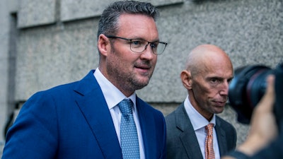 Trevor Milton, left, leaves the Thurgood Marshall United States Courthouse, Sept. 12, 2022, in New York.