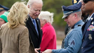 President Joe Biden and first lady Jill Biden greet Massachusetts State Police before boarding Air Force One, Nantucket Memorial Airport, Nantucket, Mass., Nov. 26, 2023.