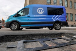 An electric van drives past a visible in-road wireless charging coil to be installed in a street in Detroit, Wednesday, Nov. 29, 2023. A demonstration of the first electric vehicle charging road in the U.S. took place Wednesday on a quarter-mile stretch of a Motor City street.
