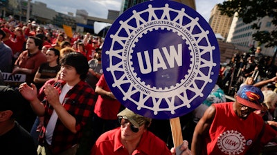 United Auto Workers members join the picket line, in Detroit, Friday, Sept. 15, 2023. General Motors says pretax earnings took a $1.1 billion hit this year from a six-week strike by autoworkers, but the company expects to absorb the costs of a new contract and is even raising its dividend. The Detroit automaker on Wednesday, Nov. 29, 2023 reinstated its full-year earnings forecast that was withdrawn after the United Auto Workers began targeting the factories of Detroit automakers with strikes on Sept. 15.