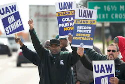 United Auto Workers members walk the picket line during a strike at the Stellantis Sterling Heights Assembly Plant, in Sterling Heights, Mich., Monday, Oct. 23, 2023. A six-week United Auto Workers strike at Ford cut sales by about 100,000 vehicles and cost the company $1.7 billion in lost profits this year, Ford said Thursday, Nov. 30, 2023.