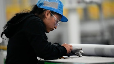 An employee at the Hanwha Qcells Solar plant, Dalton, Ga., Oct. 16, 2023.