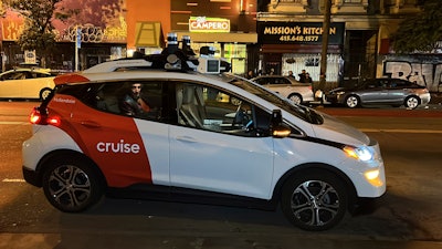 Associated Press reporter Michael Liedtke sits in the back of a Cruise driverless taxi that picked him up in San Francisco's Mission District, Feb. 15, 2023.