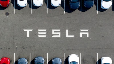 Tesla vehicles line a parking lot at the company's Fremont, Calif., factory, on Sept. 18, 2023.