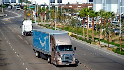 A semi-truck turns into an Amazon Fulfillment center in Eastvale, Calif. on Thursday, Nov. 12, 2020.