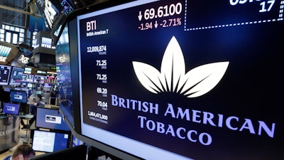The logo for British American Tobacco appears above a trading post, July 24, 2017, on the floor of the New York Stock Exchange.