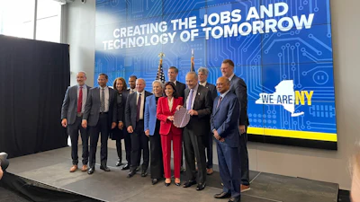 New York Gov. Kathy Hochul and Sen. Chuck Schumer hold a silicon wafer and pose for a photo with lawmakers and leaders from the semiconductor industry during an event at NY CREATES’ Albany NanoTech Complex.