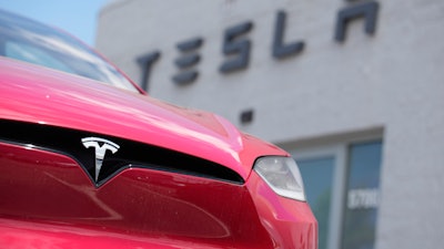 An unsold 2023 Model X sports-utility vehicle sits outside a Tesla dealership June 18, 2023, in Littleton, Colo.