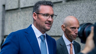 Trevor Milton, left, leaves the Thurgood Marshall United States Courthouse, Sept. 12, 2022, in New York.