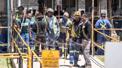 Mineworkers at the entrance of a goldmine in Springs, near Johannesburg, South Africa, Wednesday, Oct. 25, 2023.