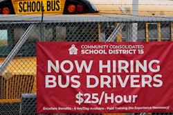A hiring sign is displayed at a school in Palatine, Ill., Wednesday, Nov. 8, 2023. On Thursday, the Labor Department reports on the number of people who applied for unemployment benefits last week.