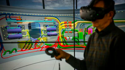 Jim Maul, senior staff engineer, propulsion systems, Northrop Grumman, demonstrates the use of tools in virtual reality.