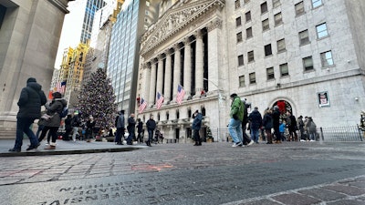 People gather near the New York Stock Exchange, Jan. 2, 2024.