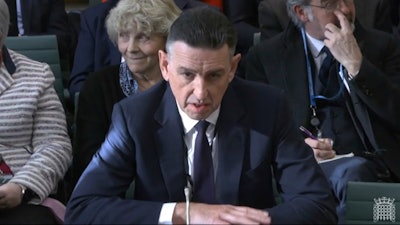 In this image taken from video made available by House of Commons, Paul Patterson, director of Fujitsu Services Ltd, gives evidence to the Business and Trade Committee at the Houses of Parliament, London, Tuesday Jan. 16, 2024.