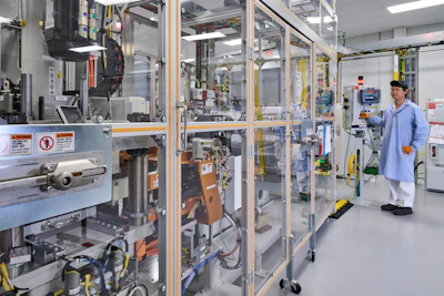 An employee monitors progress of fuel cell electrodes in the stack assembly room at Fuel Cell System Manufacturing LLC, GM and Honda’s fuel cell joint venture in Brownstown, Michigan.