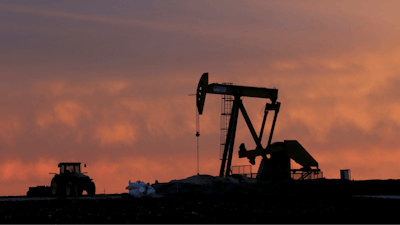 A well pump works at sunset on a farm near Sweetwater, Texas, on Dec. 22, 2014.