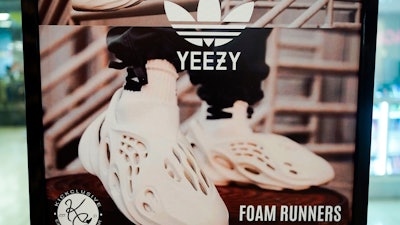 A sign advertises Yeezy shoes made by Adidas at Kickclusive, a sneaker resale store, in Paramus, N.J., Oct. 25, 2022.