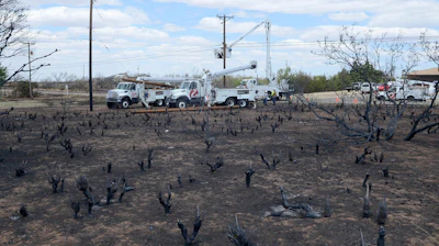 Xcel Energy crews begin replacing hundreds of power poles in Fritch, Texas, May, 13, 2014 after a devastating wildfire tore through the small community Sunday evening.