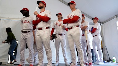 Philadelphia Phillies players wait to have their photo taken during a baseball spring training photo day Thursday, Feb. 22, 2024, in Clearwater, Fla.