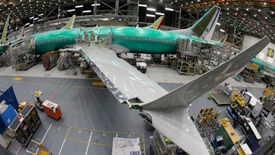 In this photo taken with a fish-eye lens, a Boeing 737 MAX 8 airplane sits on the assembly line during a brief media tour in Boeing's 737 assembly facility in Renton, Wash., March 27, 2019.