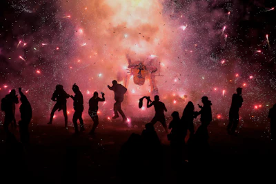 People dance and dodge a giant paper-mache bull stuffed with fireworks as roman candles and bottle rockets shower them with sparks, during the annual festival honoring Saint John of God, in Tultepec, Mexico, Friday, March 8, 2024. The celebration, now its 35th year, pays homage to the patron saint of the poor and sick, St. John of God, who the fireworks' producers view as a protective figure.