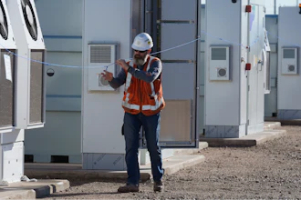Workers do checks on battery storage pods at Orsted's Eleven Mile Solar Center lithium-ion battery storage energy facility Thursday, Feb. 29, 2024, in Coolidge, Ariz.