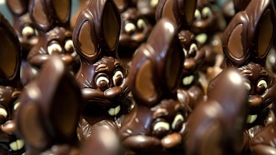 Chocolate rabbits wait to be decorated at the Cocoatree chocolate shop, April 8, 2020, in Lonzee, Belgium.