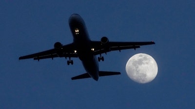A commercial airliner approaches Chicago's O'Hare International Airport, Feb. 21, 2024, in Norridge, Ill.