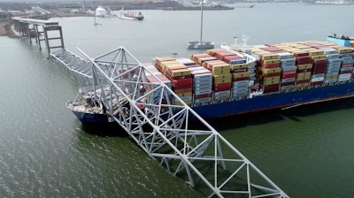 In this image taken from video released by the National Transportation and Safety Board, the cargo ship Dali is stuck under part of the structure of the Francis Scott Key Bridge after the ship hit the bridge, Tuesday, March 26, 2024, in Baltimore.