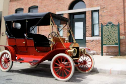 A 1909 Model T in front of the factory where it was made, the Ford Piquette Avenue Plant.