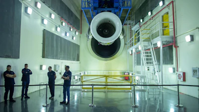 Engineers and workers stand inside Safran Aircraft Engines repair plant outside of Casablanca, Morocco, Thursday, April 18, 2024.