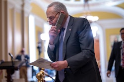 Senate Majority Leader Chuck Schumer, D-N.Y., talks on his phone on the way to a closed-door Democratic strategy session, at the Capitol in Washington, Wednesday, March 20, 2024.