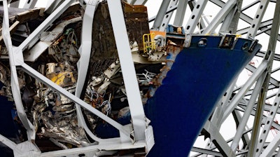 Wreckage of the Francis Scott Key Bridge rests on the container ship Dali, Wednesday, April 3, 2024, in Baltimore.