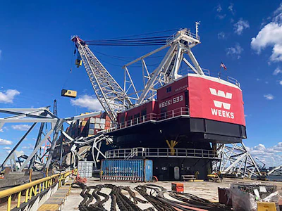 from the deck of the cargo ship Dali using a floating crane barge at the site of the Francis Scott Key Bridge, Sunday, April 7, 2024, in Baltimore.