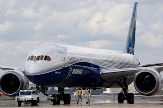 Boeing employees walk the new Boeing 787-10 Dreamliner down towards the delivery ramp area at the company's facility after conducting its first test flight at Charleston International Airport, Friday, March 31, 2017, in North Charleston, S.C.