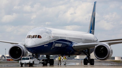 Boeing employees walk the new Boeing 787-10 Dreamliner down towards the delivery ramp area at the company's facility after conducting its first test flight at Charleston International Airport, Friday, March 31, 2017, in North Charleston, S.C.