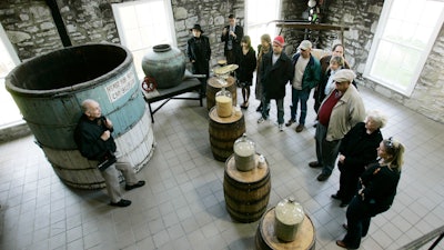 Guide Dave Salyers describes the bourbon-making process to a group touring the Woodford Reserve distillery, Versailles, Ky., April 8, 2009.