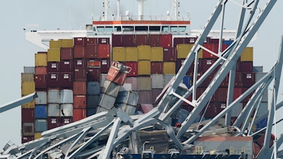 The container ship Dali is stuck under part of the Francis Scott Key Bridge after the ship hit the bridge, March 26, 2024, in Baltimore, Md.