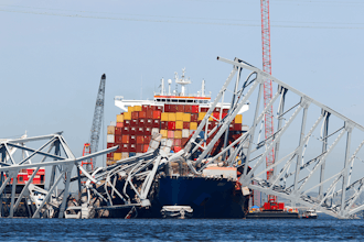 The collapsed Francis Scott Key Bridge lay on top of the container ship Dali, Monday, April 15, 2024, in Baltimore.