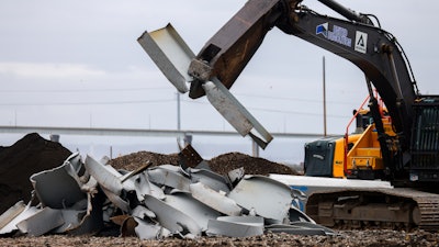 A machine splits a piece recovered from the collapsed Francis Scott Key Bridge at Tradepoint Atlantic on April 12, 2024, in Sparrows Point, Maryland.