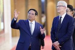 Vietnamese Prime Minister Pham Minh Chinh, left, speaks to Apple CEO Tim Cook, right, before their meeting in Hanoi, Vietnam on Tuesday, April 16, 2024.