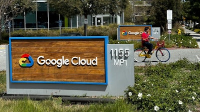 A person rides past the Google sign outside the Google offices in Sunnyvale, Calif., on Thursday, April 18, 2024.