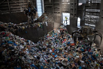 Cranes lift waste, mostly plastic and paper at the GreenNet recycling plant in Atarot industrial zone, north of Jerusalem, Jan. 25, 2023.